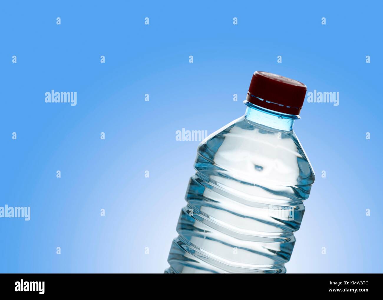 https://c8.alamy.com/comp/KMW8TG/purified-spring-water-in-the-bottle-over-clear-blue-background-KMW8TG.jpg