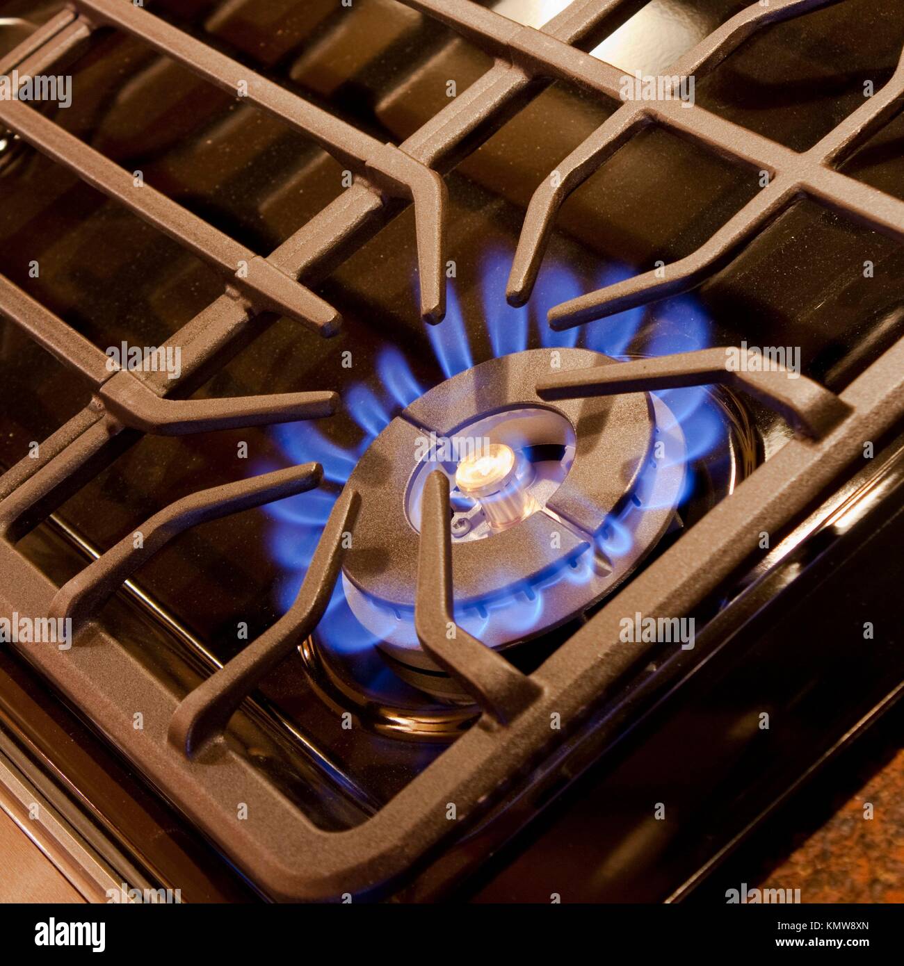 A blue flame from a gas cooktop burner Stock Photo Alamy