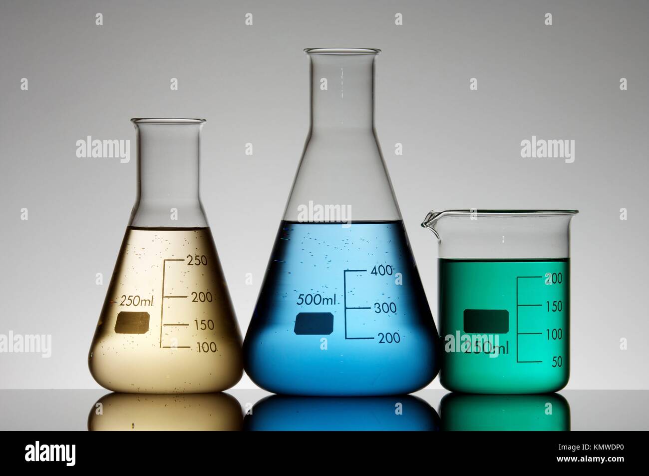 three flasks to measure liquids in a chemical laboratory Stock Photo