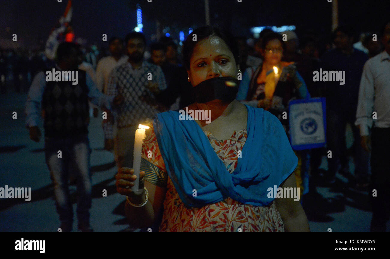 A woman, supporter of Trinamool Congress hold a candle during a candle ...