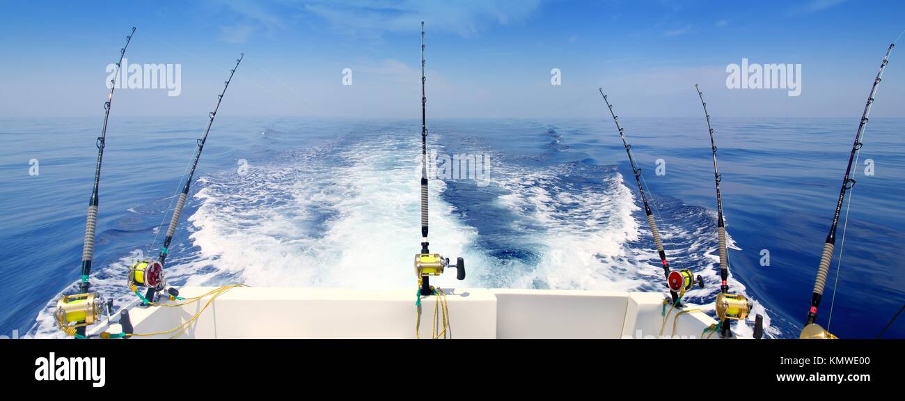 boat fishing trolling panoramic rod and reels blue sea wake Stock Photo -  Alamy