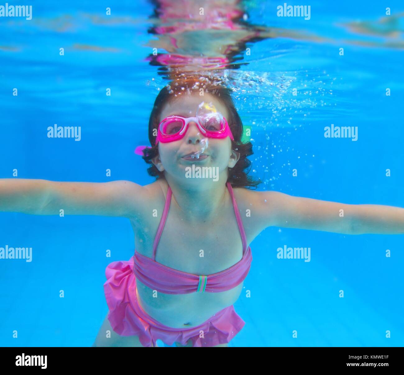 underwater little girl pink bikini goggles blue swimming pool ...