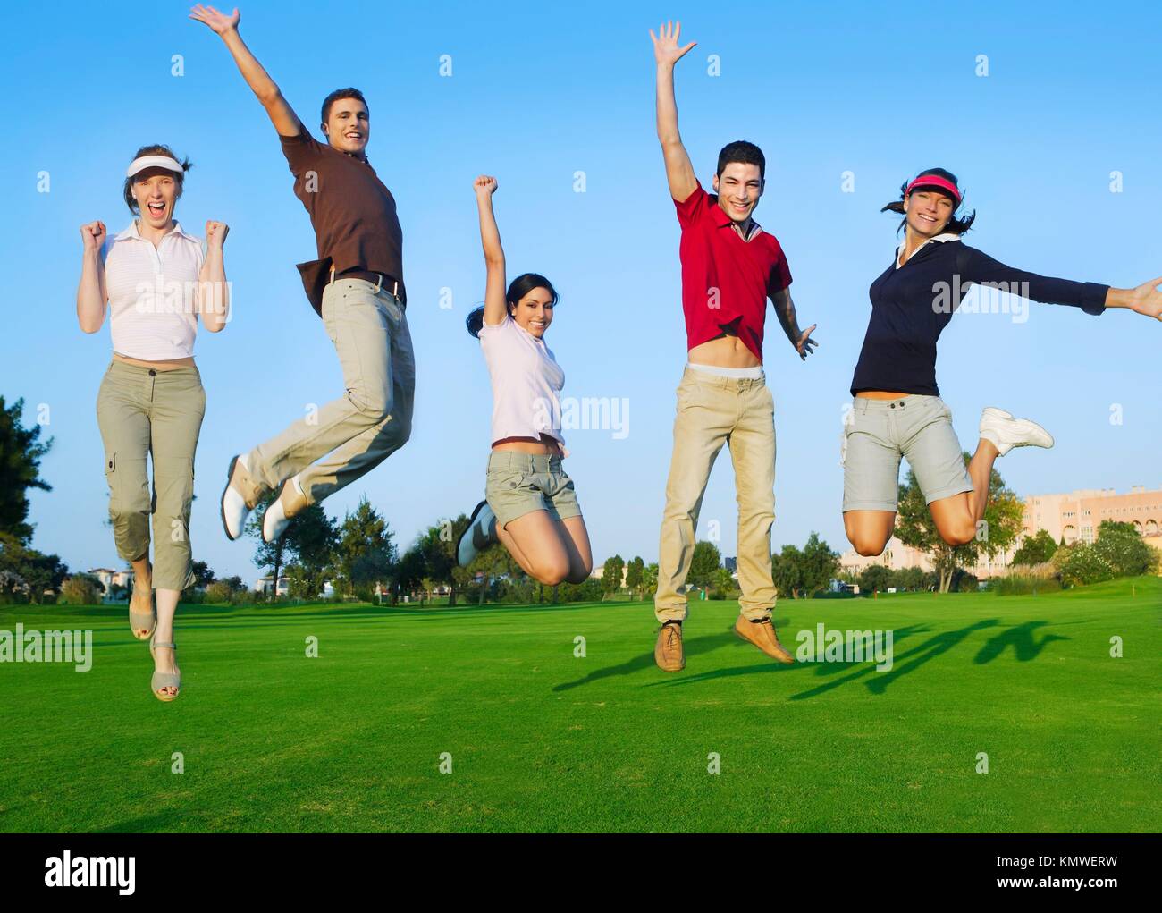 happy jump group of young people jumping outdoors grass Stock Photo Alamy