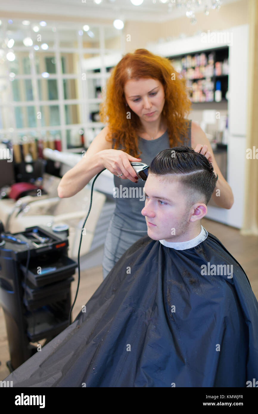 Girl Hairdresser With Curly Red Hair Cuts Young Handsome
