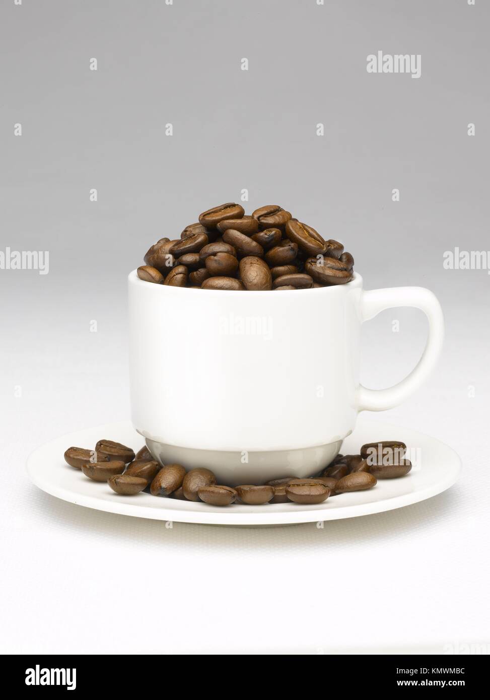Coffee beans cup overflowing Stock Photo Alamy