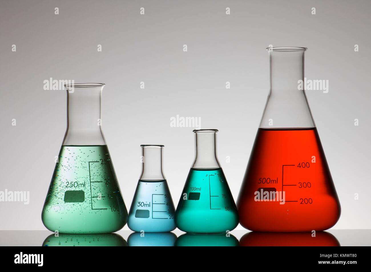 four conical glass flasks in a chemistry lab Stock Photo Alamy