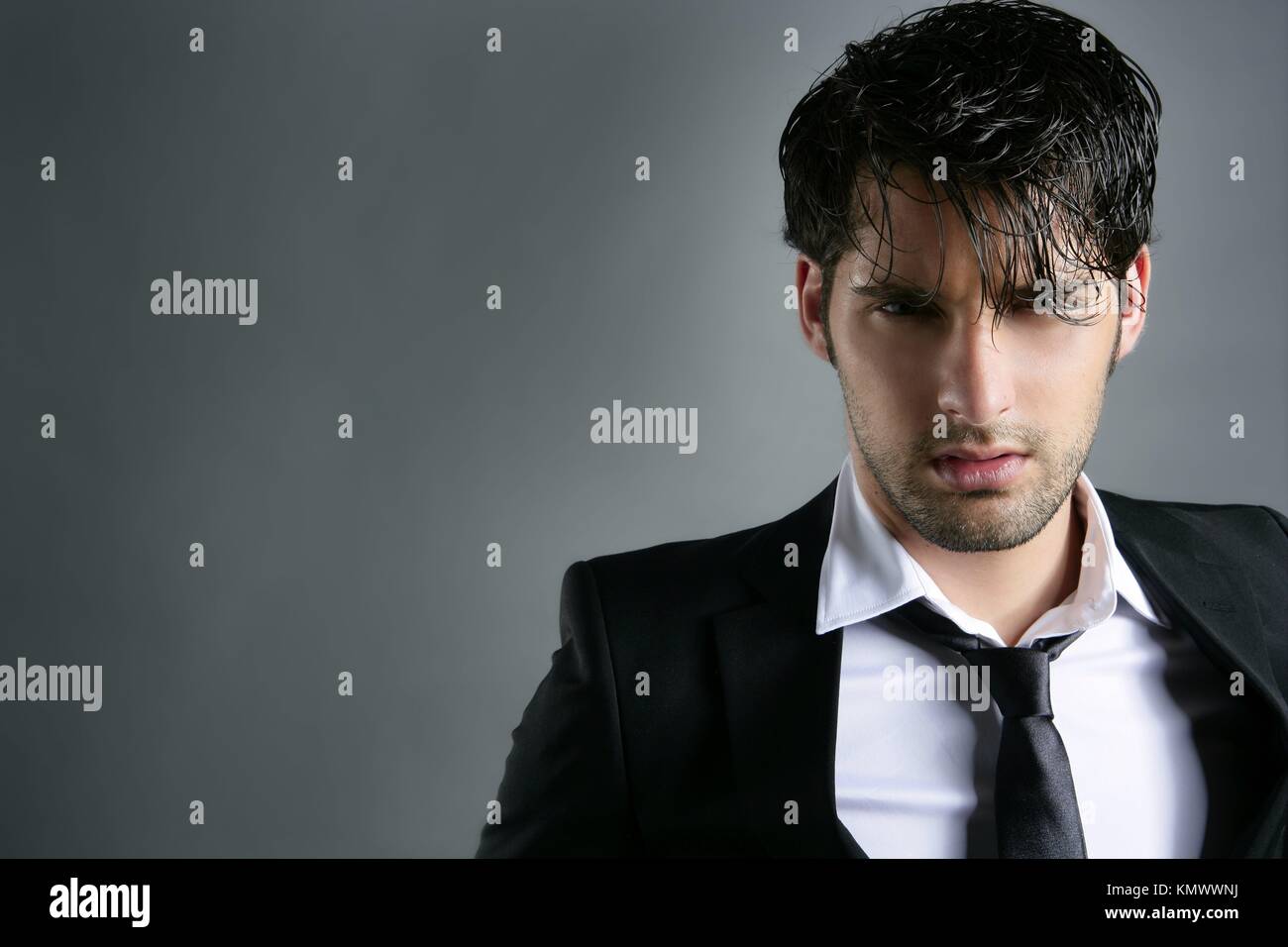 Fashion trendy suit young handsome man messy hairstyle dark portrait on gray Stock Photo - Alamy Fashion trendy suit young handsome man messy hairstyle dark portrait on gray Stock Photo - Alamy