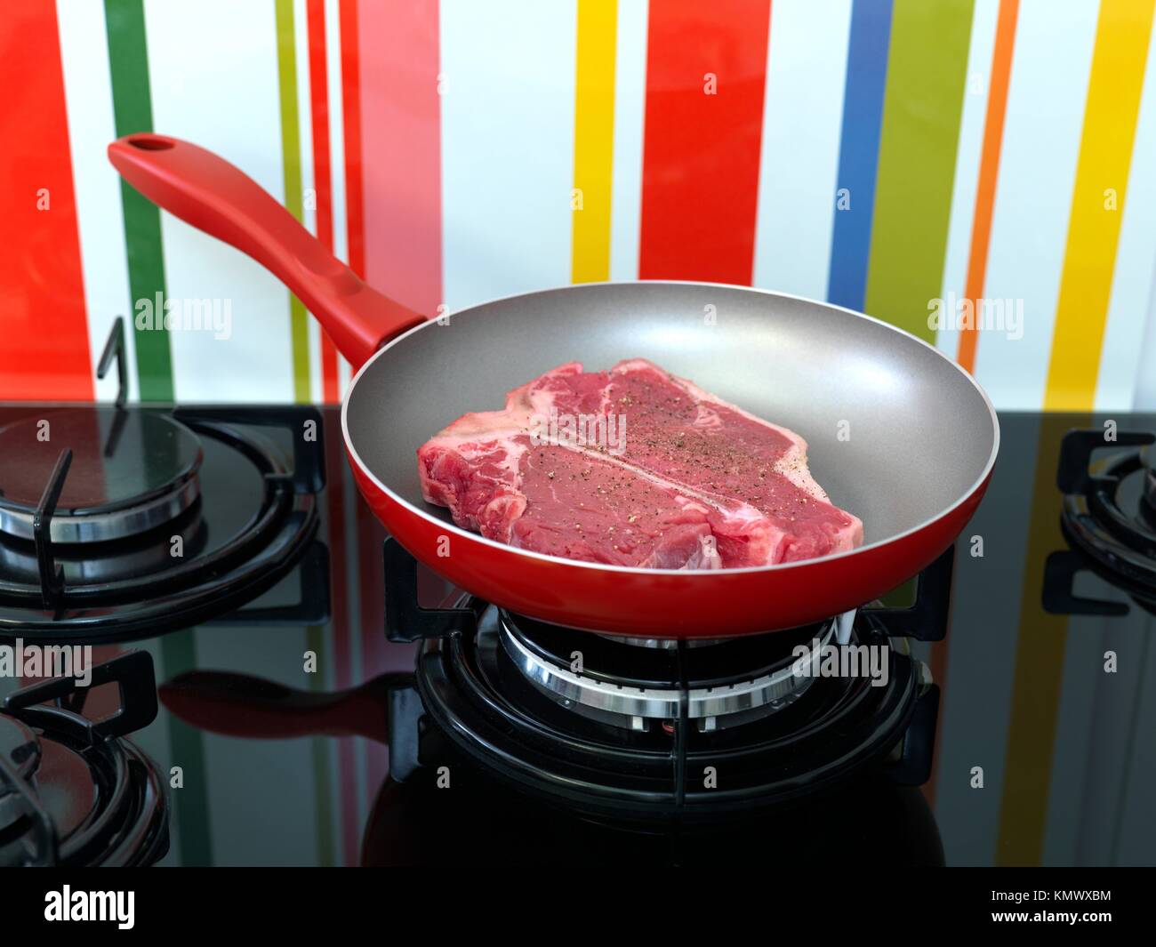 A T Bone steak in a frying pan on a stove top Stock Photo Alamy