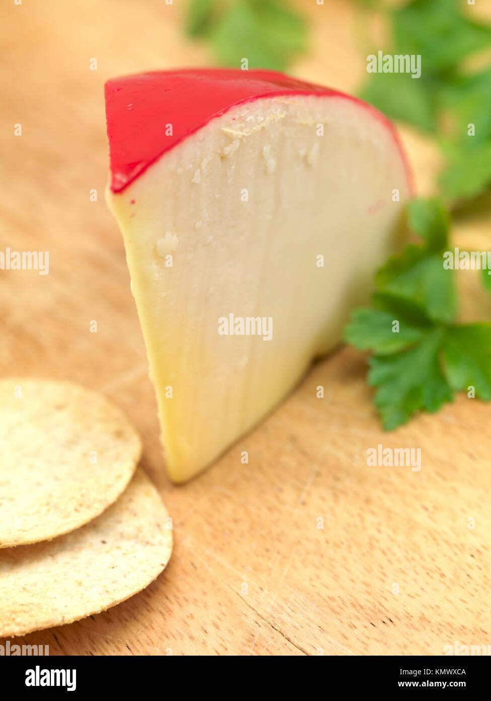 Gouda cheese isolated on a wooden cutting board Stock Photo Alamy