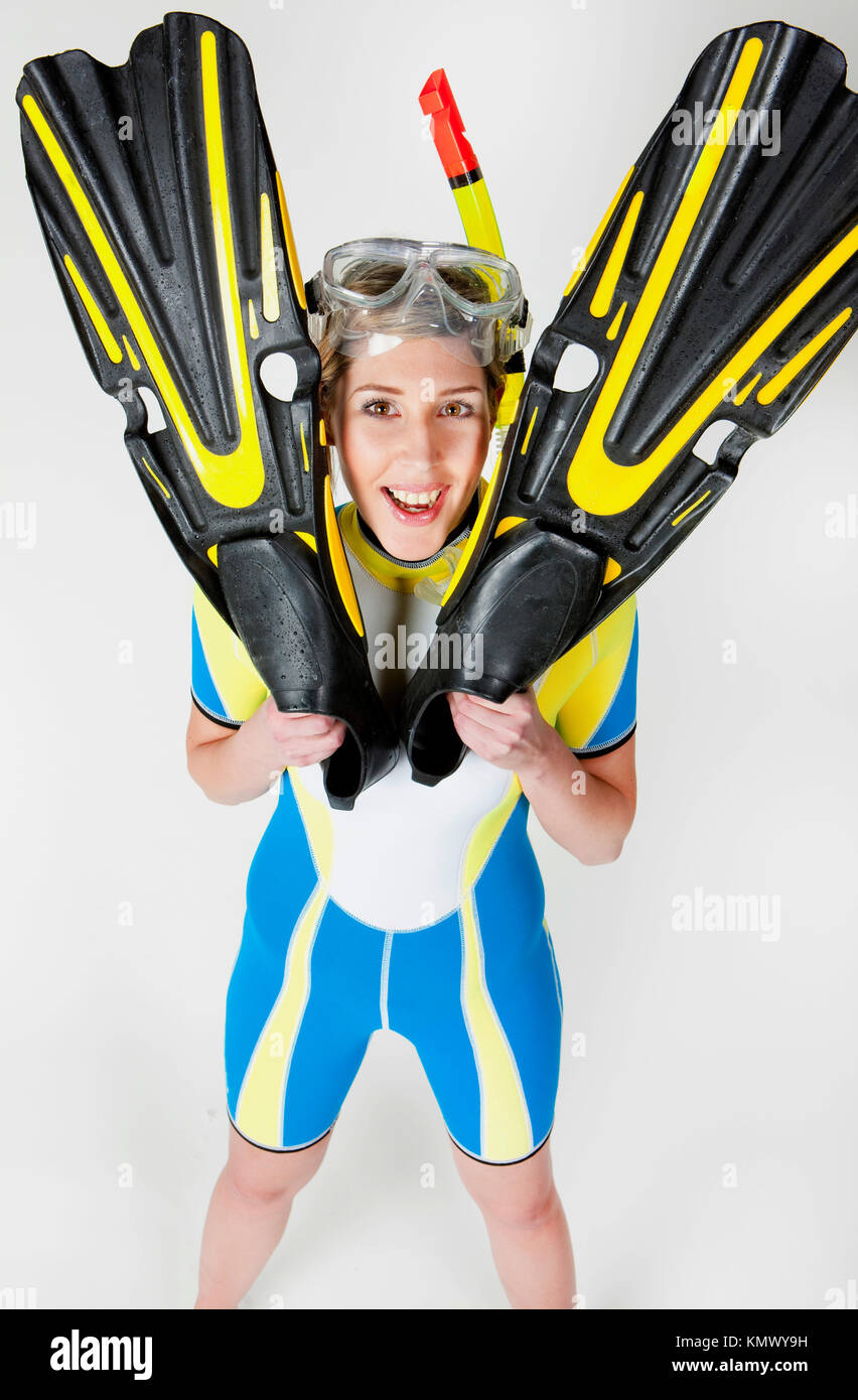 portrait of woman wearing neoprene with flippers and diving goggles