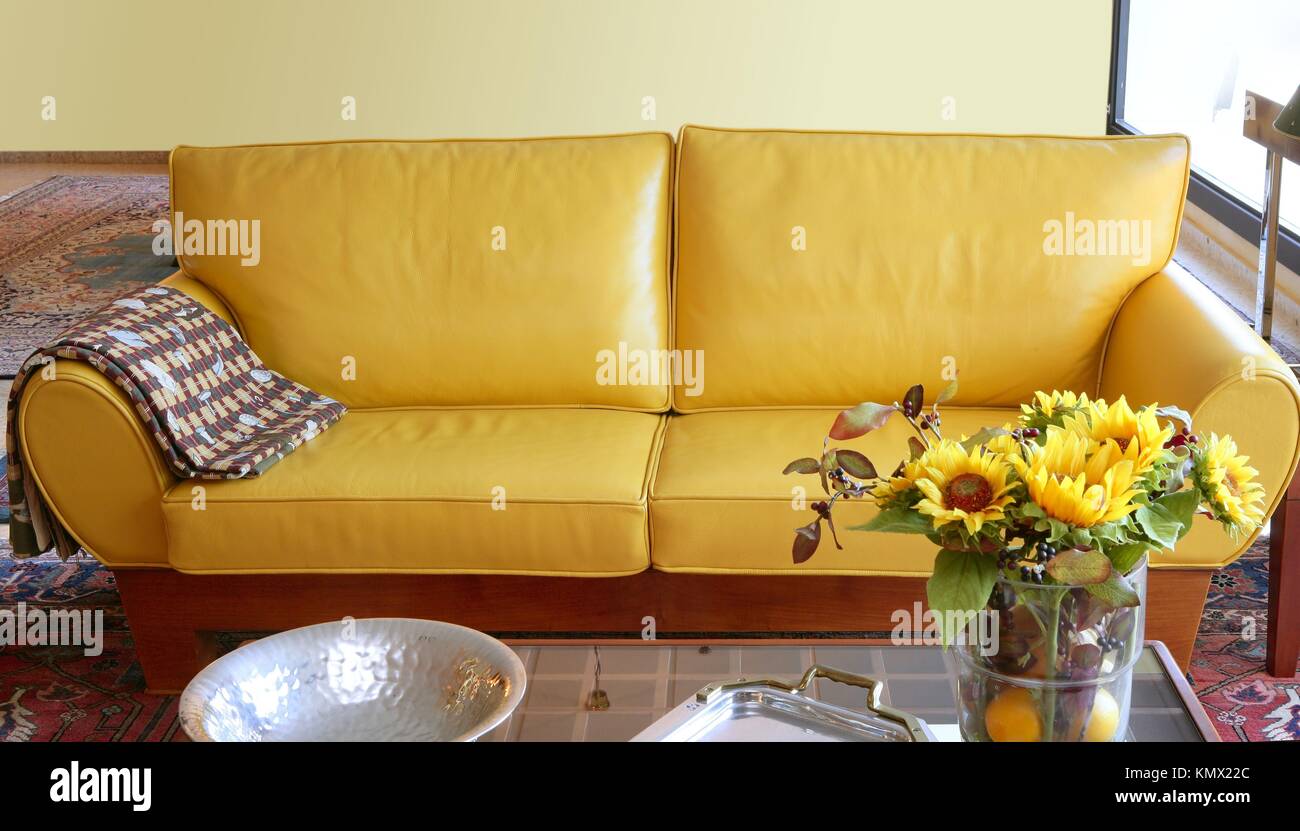 Yellow leather sofa couch interior sunflower bouquet Stock Photo - Alamy