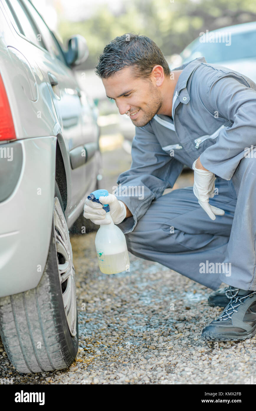 Mechanic cleaning a hubcap Stock Photo Alamy