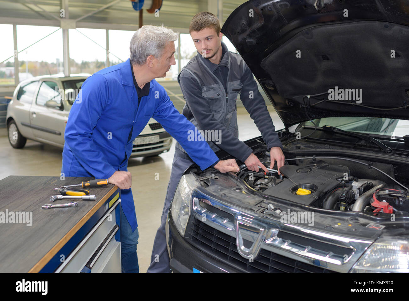 student mechanic learning from teacher in automotive vocational school  Stock Photo - Alamy