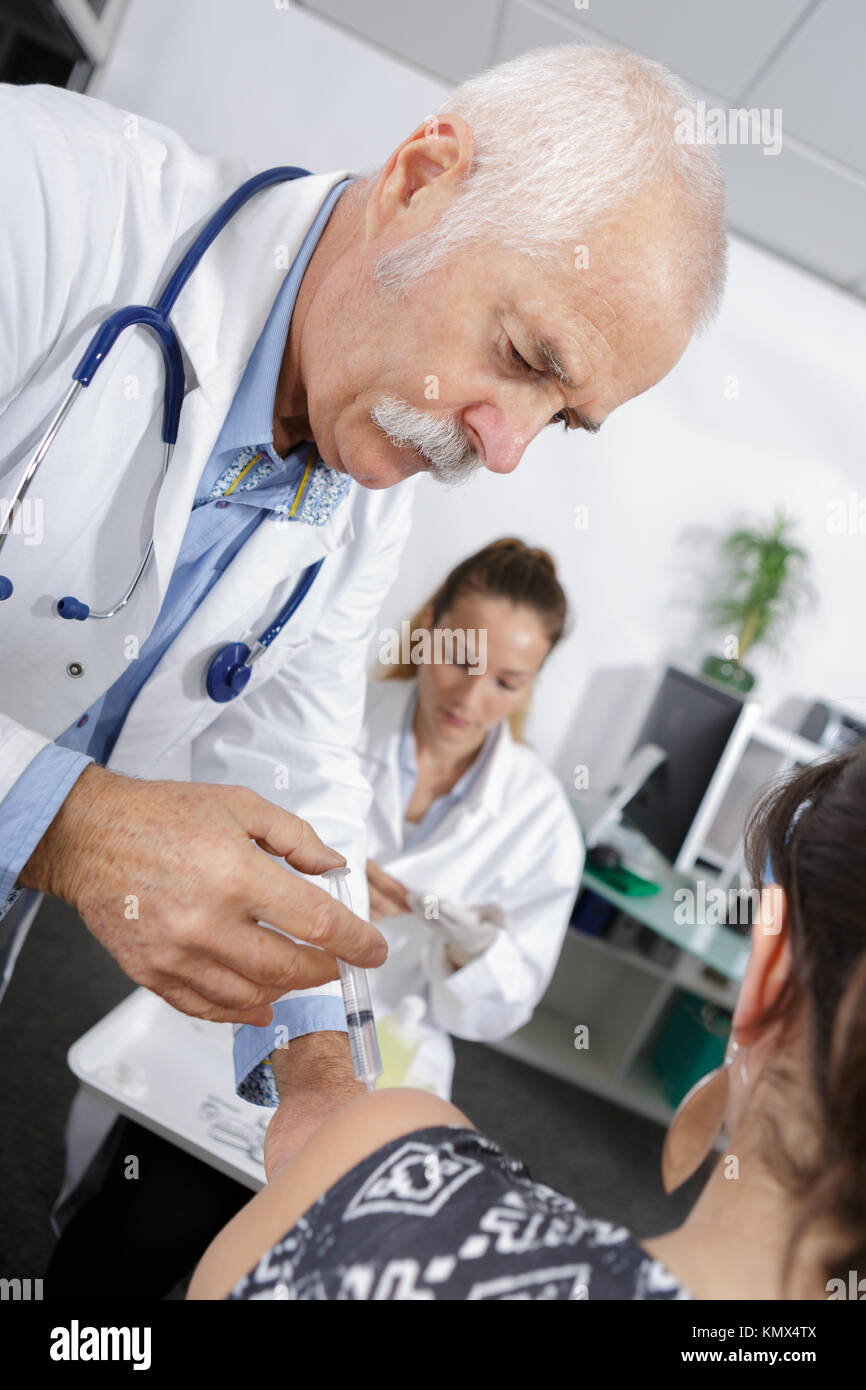Doctor administering vaccine hi-res stock photography and images - Alamy