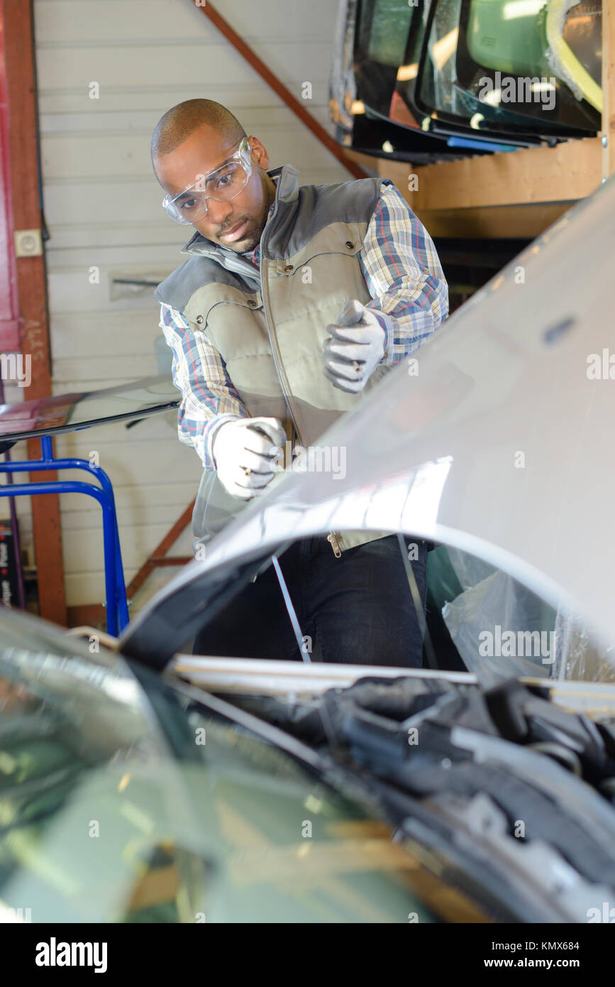 mechanic leaning back to look a car engine Stock Photo Alamy