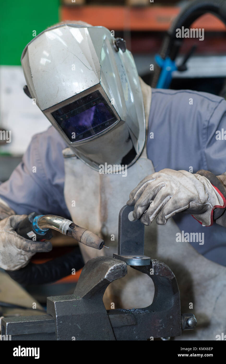 welder in mask welding metal and sparks metal close Stock Photo
