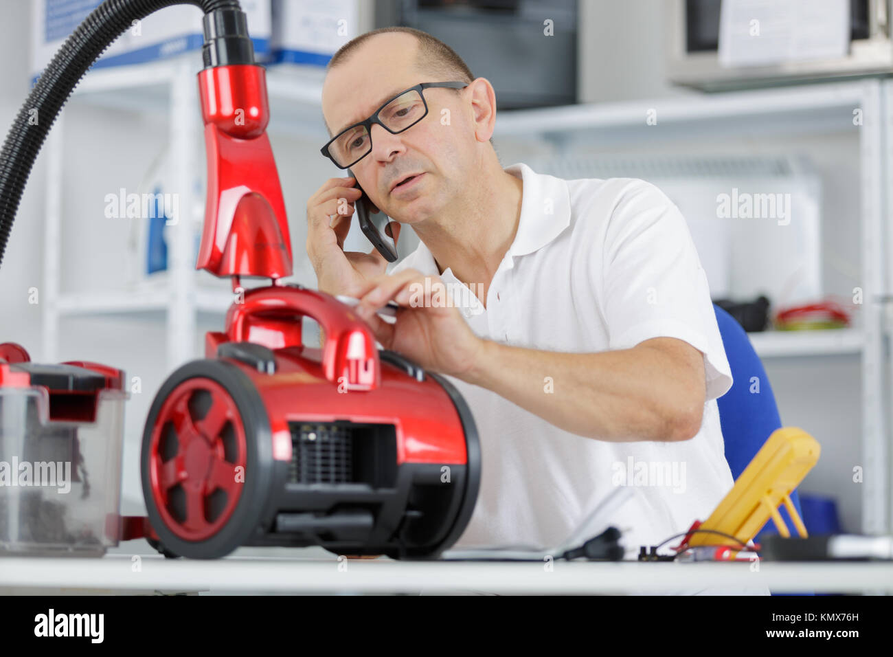 Electrician working on vacuum Stock Photo Alamy
