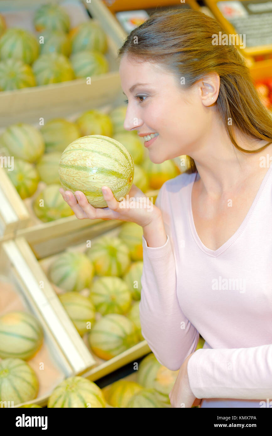 woman choosing melons Stock Photo Alamy