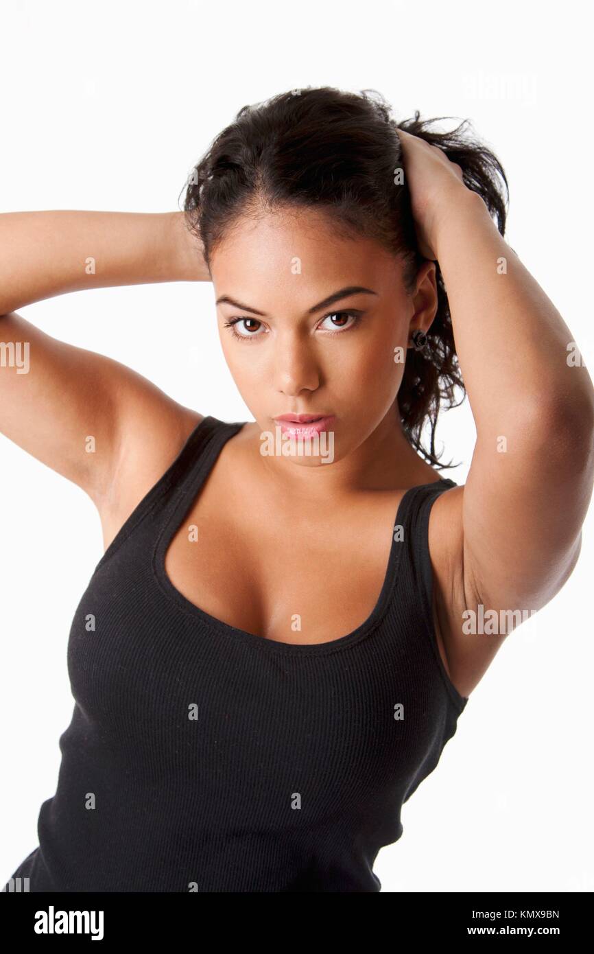 Beautiful Hispanic woman with tanned skin holding pulling up long black  hair wearing tank top, isolated Stock Photo - Alamy