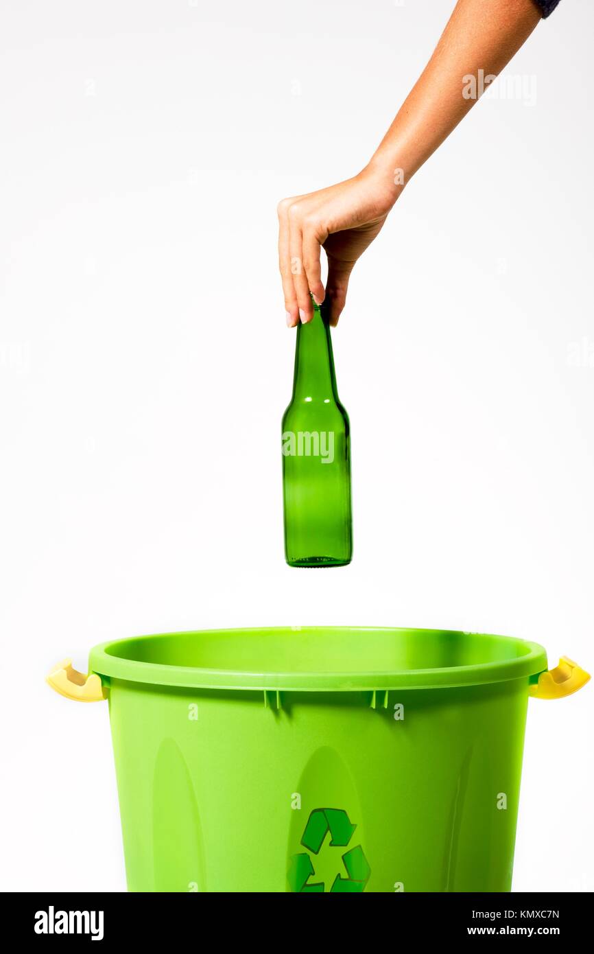 Woman´s hand putting a glass bottle into a recycling bin Stock Photo Alamy