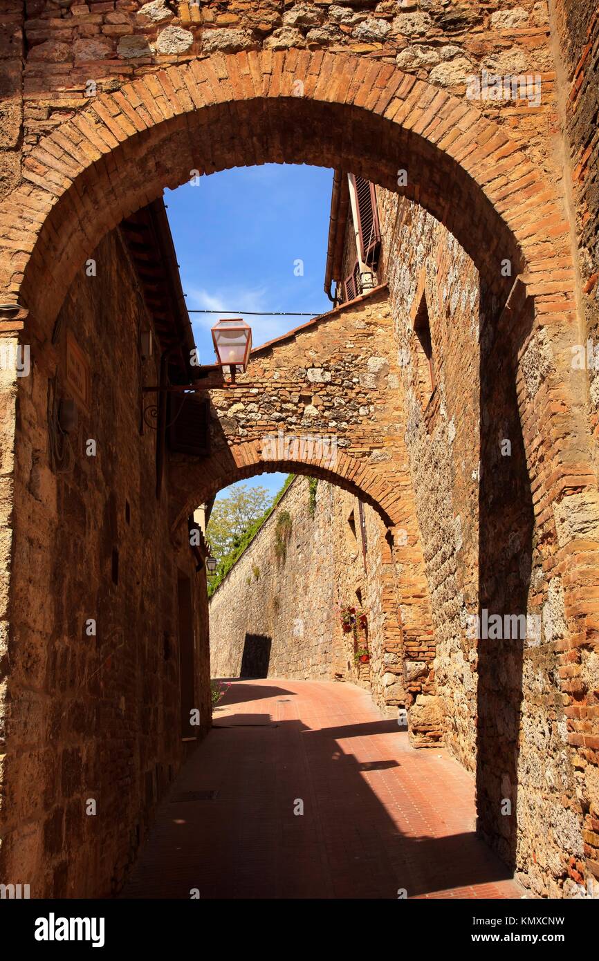 Ancient Stone Arches Street Flowers Medieval Town San Gimignano Tuscany ...
