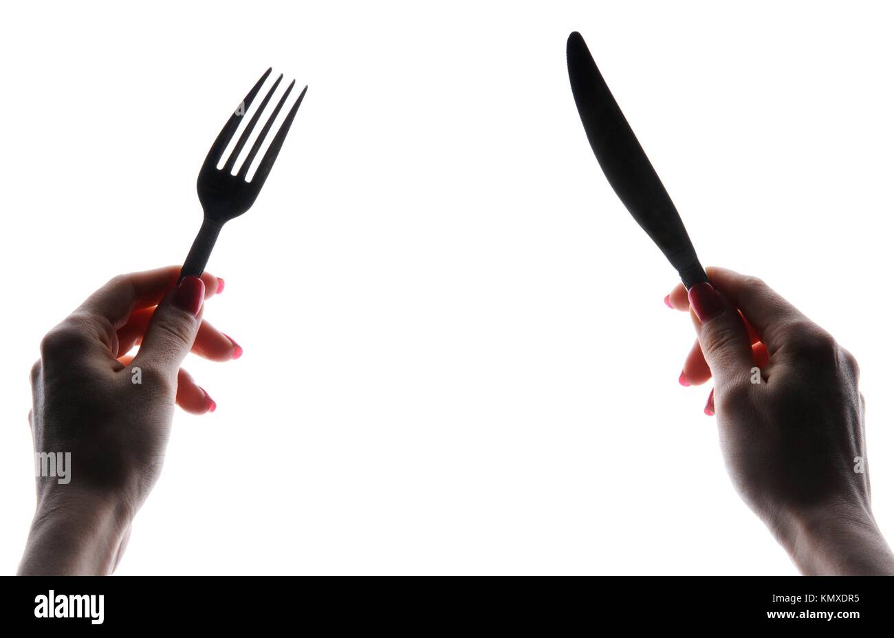 Woman´s hands holding knife and fork, isolated on white background