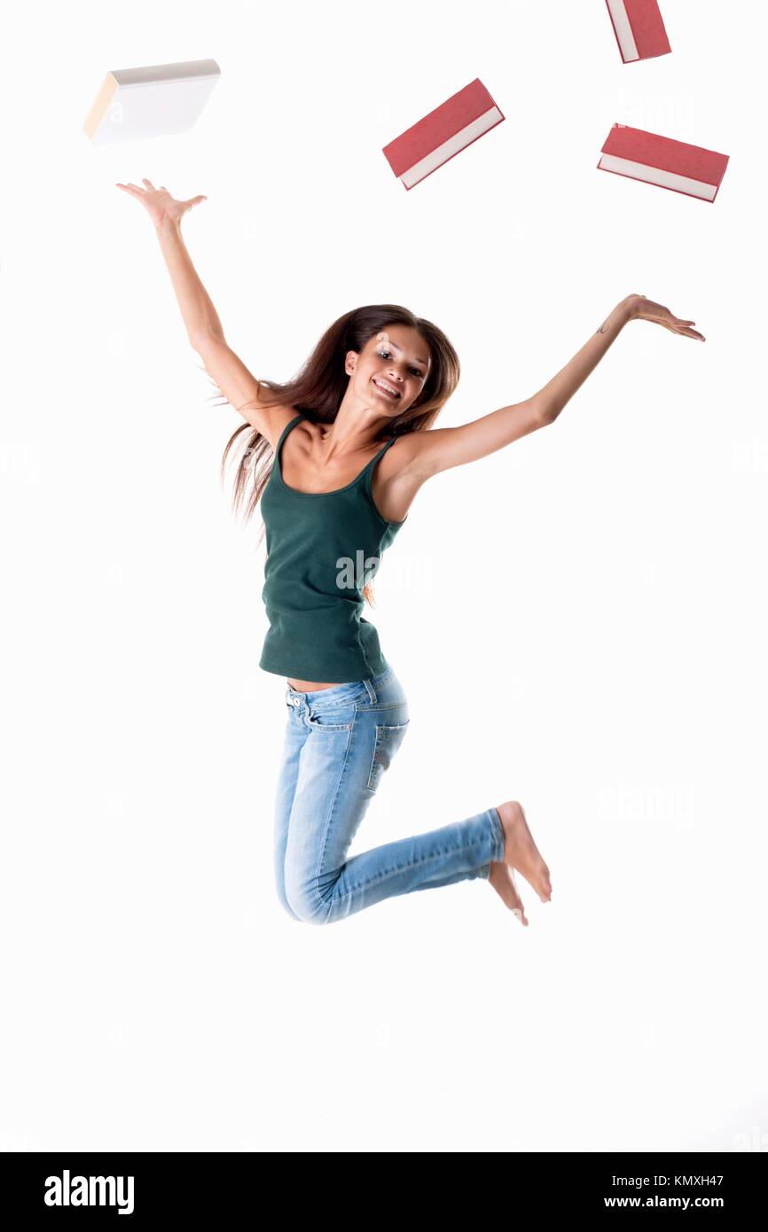 Happy student jumping, throwing books away Concept end of school Stock