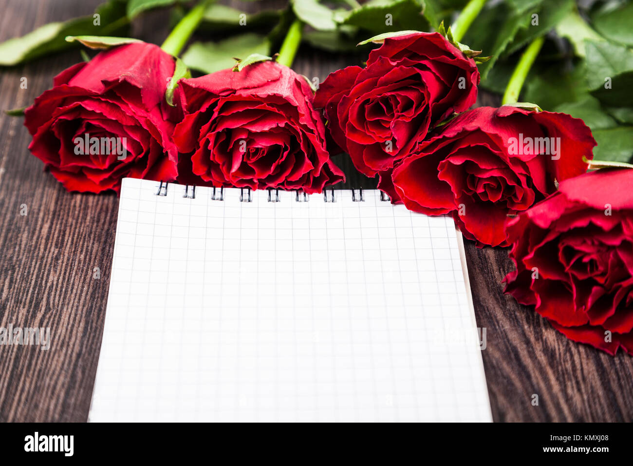 Red roses and card on a wooden background. Greeting card with Valentine ...