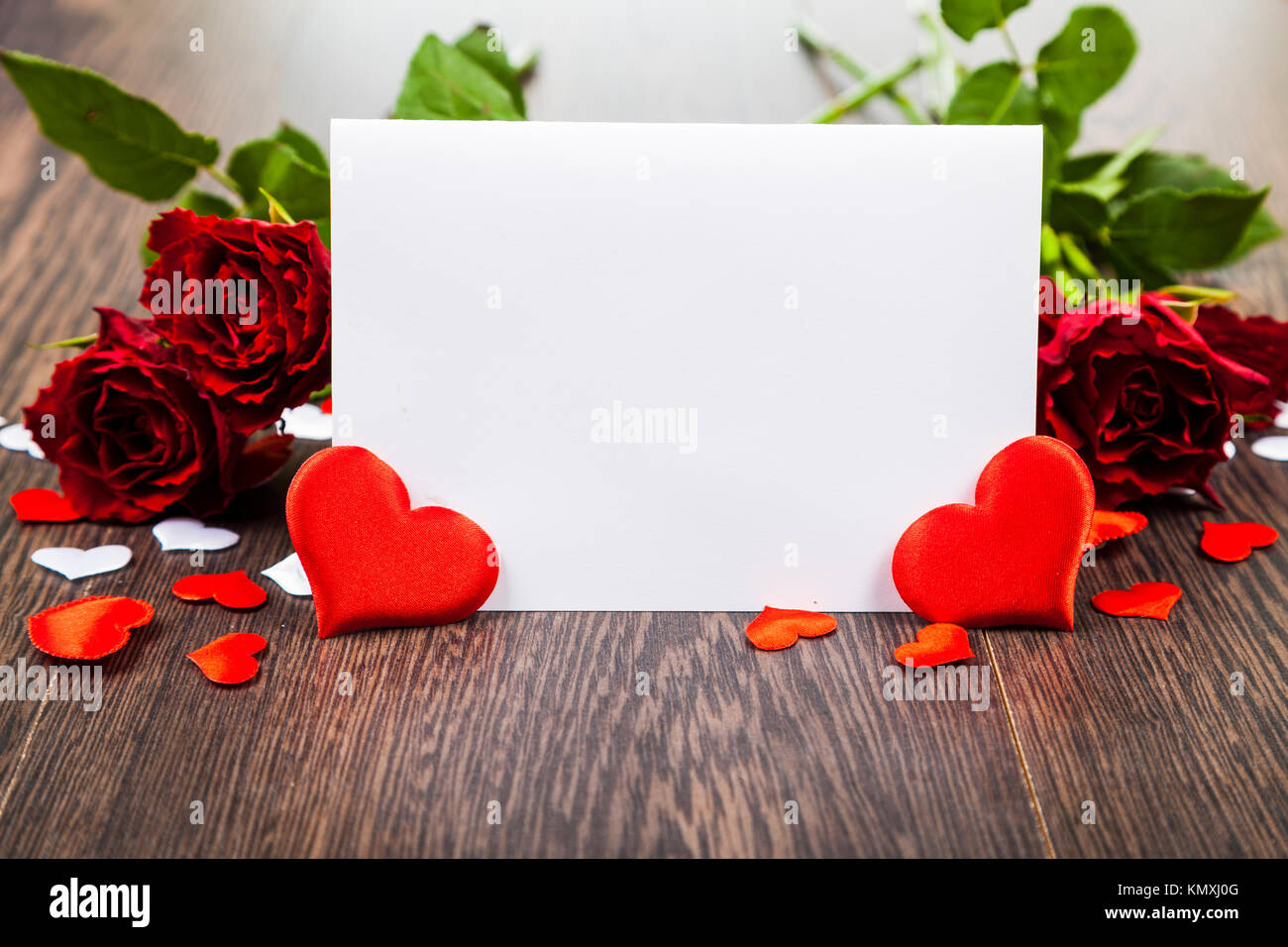 Red roses and card on a wooden background. Greeting card with Valentine ...
