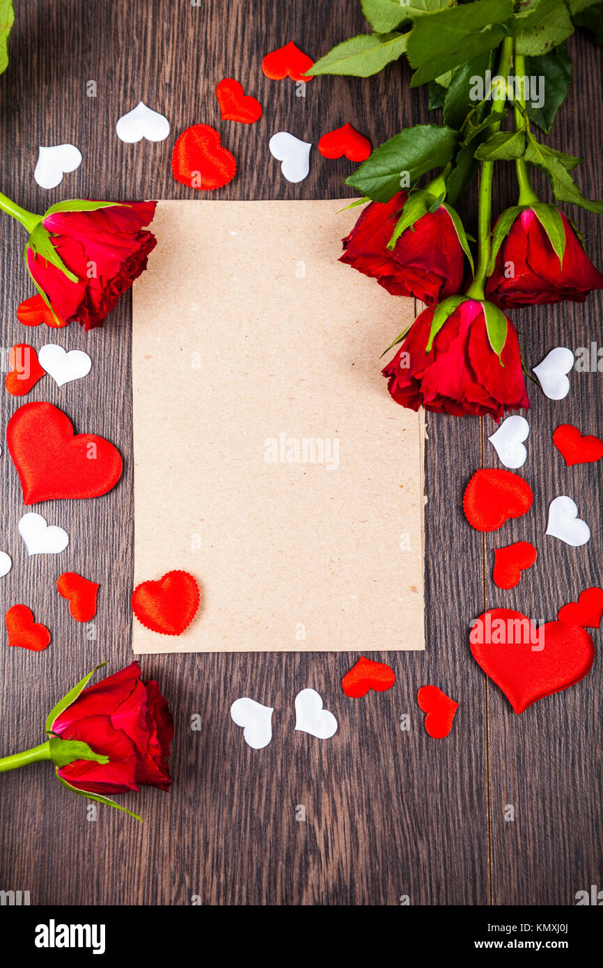 Red roses and card on a wooden background. Greeting card with Valentine ...
