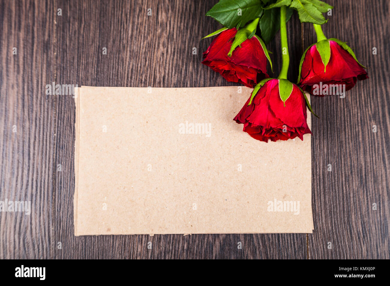 Red roses and card on a wooden background. Greeting card with Valentine ...