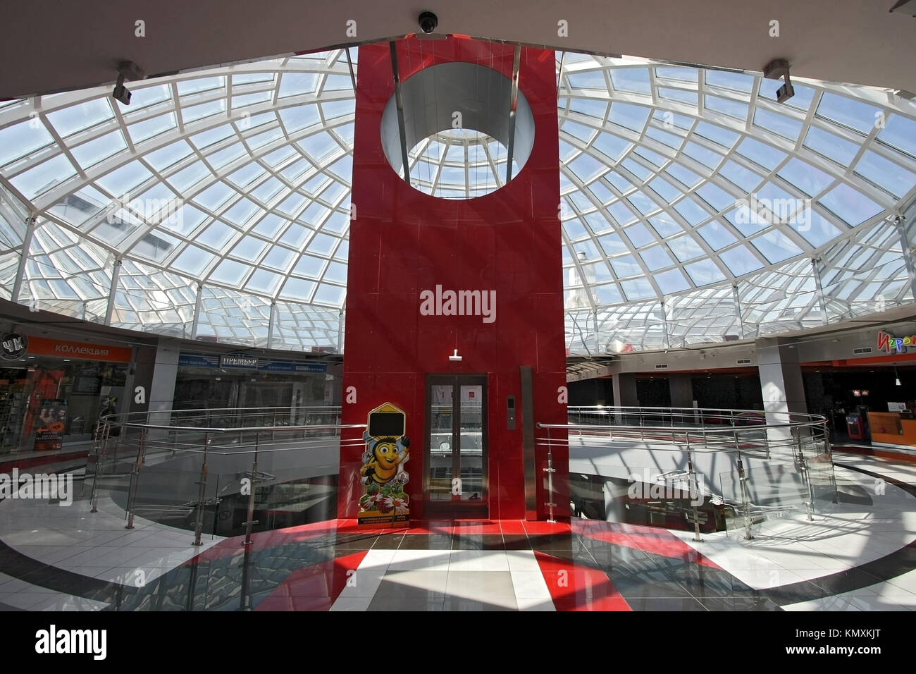 Huge hall of modern shopping centre with the glass lift and a transparent  glass dome Stock Photo - Alamy