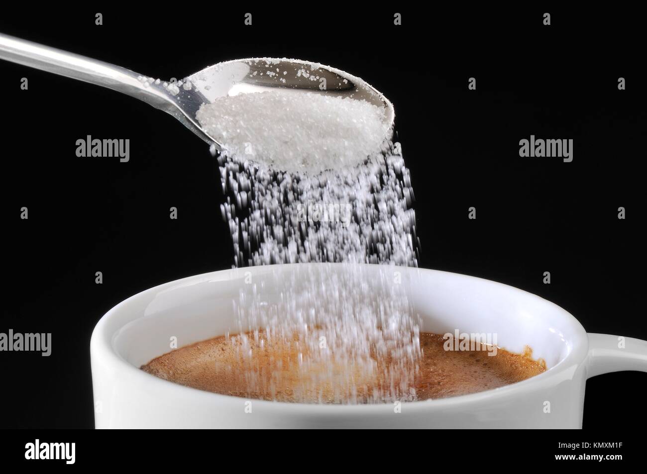 putting sugar in coffee Stock Photo Alamy