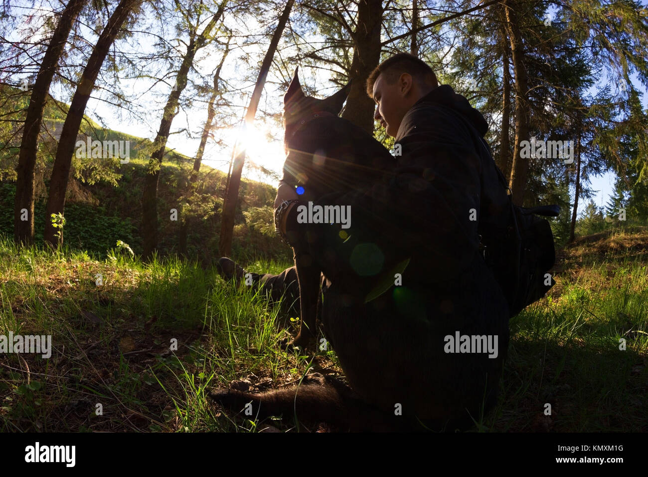 unusual shot of men and his dog in a forest Stock Photo - Alamy