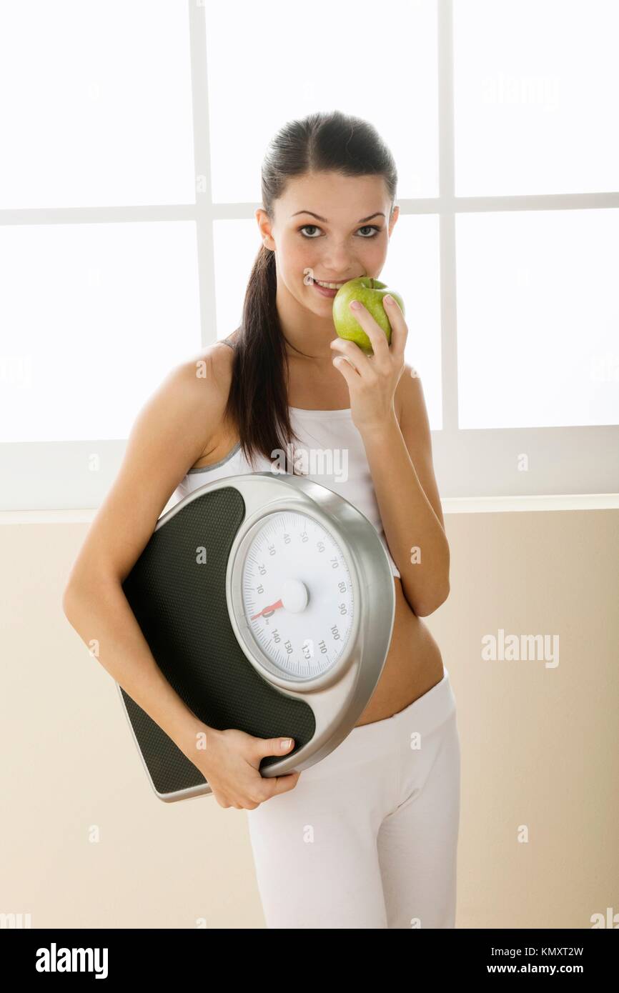 Young woman holding weight scale Stock Photo
