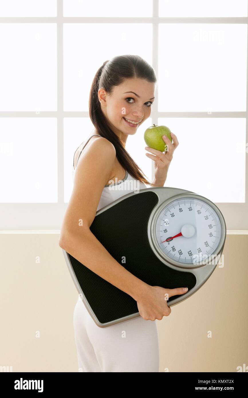 Young woman holding weight scale Stock Photo