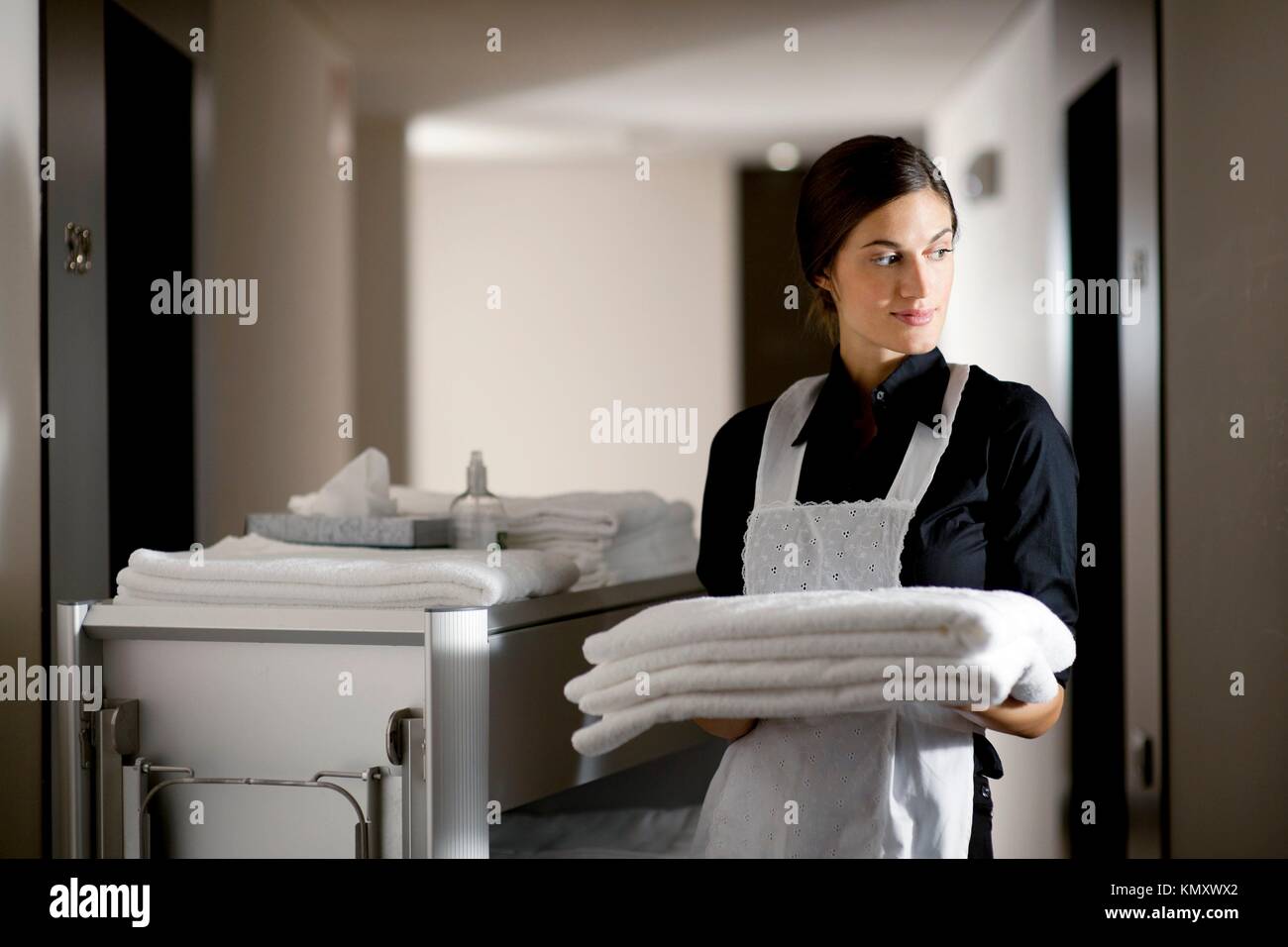 Maid with housekeeping cart Stock Photo Alamy