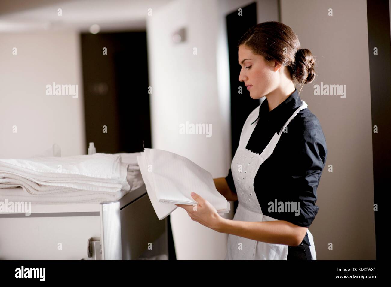 Maid with housekeeping cart Stock Photo Alamy