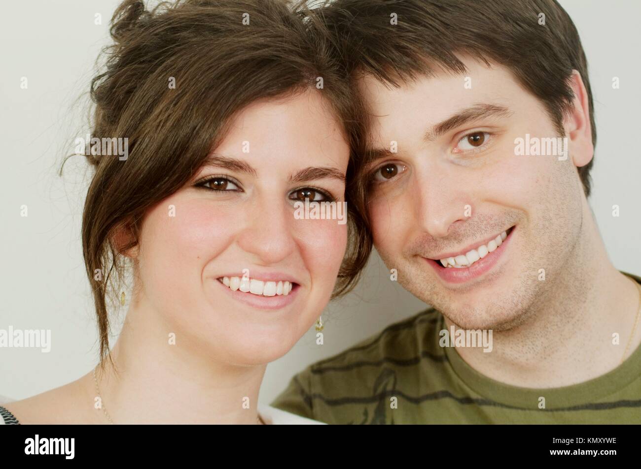 Young couple smiling and looking at the camera. Close view Stock Photo ...