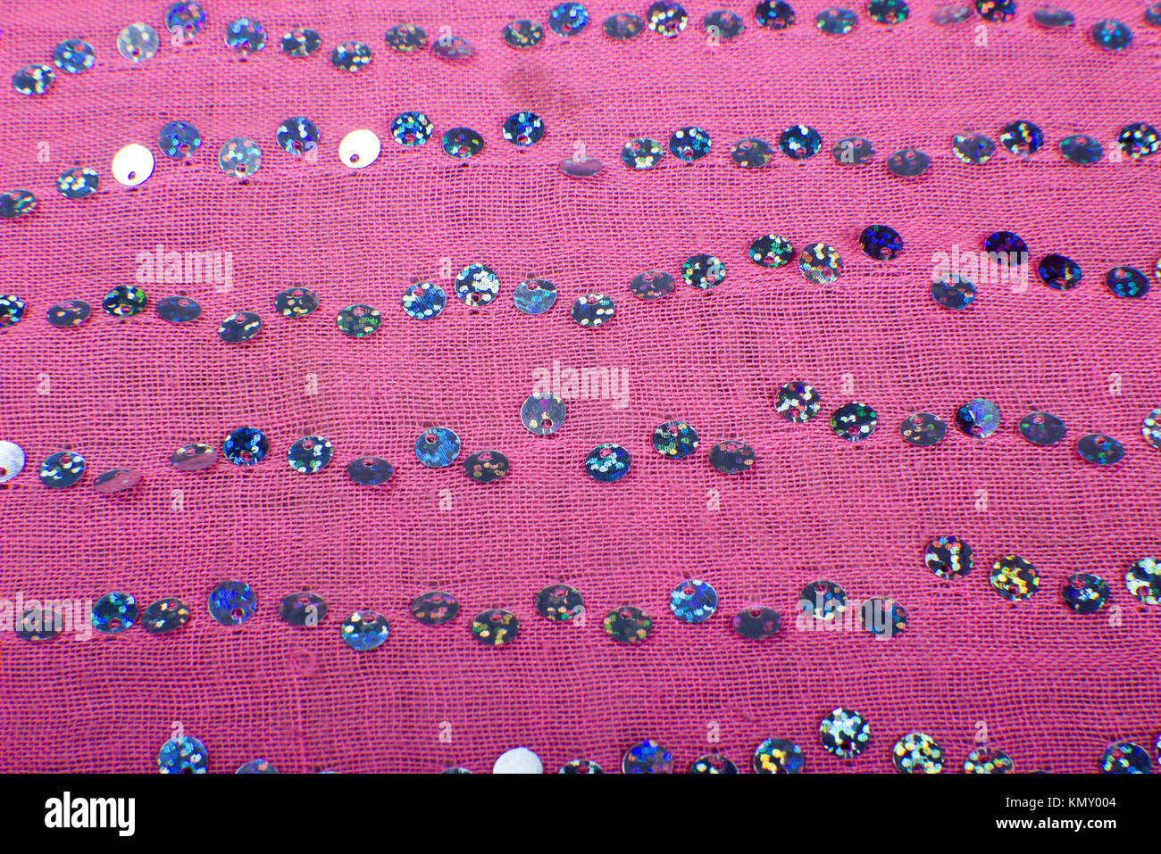 abstract background of a close up portrait of sequined pink fabric scarf Stock Photo