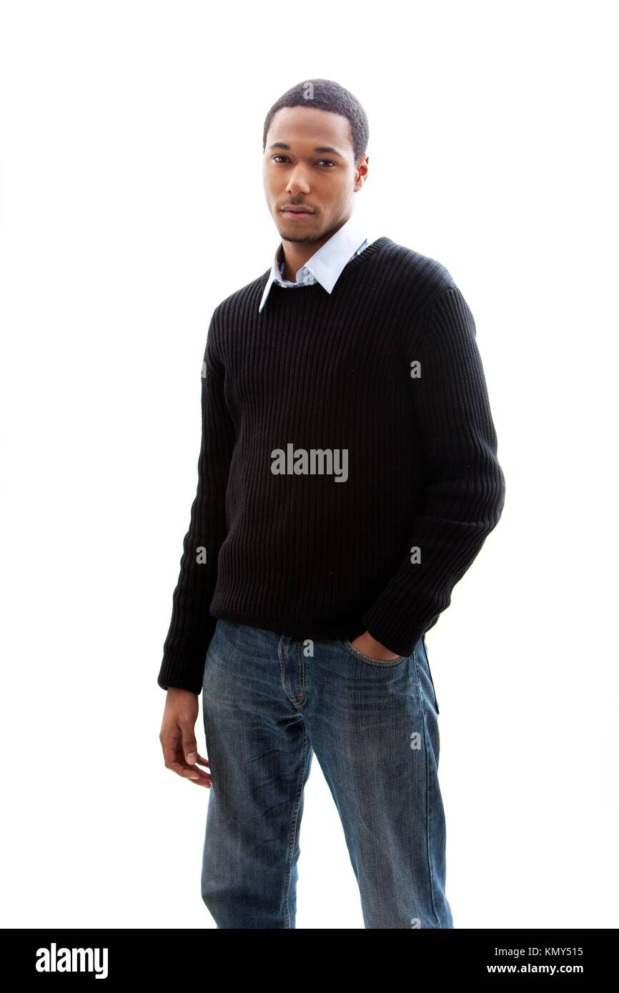 Handsome African American male in blue shirt black sweater and jeans  standing, isolated Stock Photo - Alamy