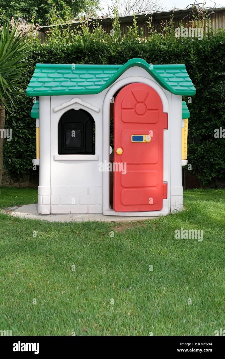 Toy house in the garden Stock Photo - Alamy