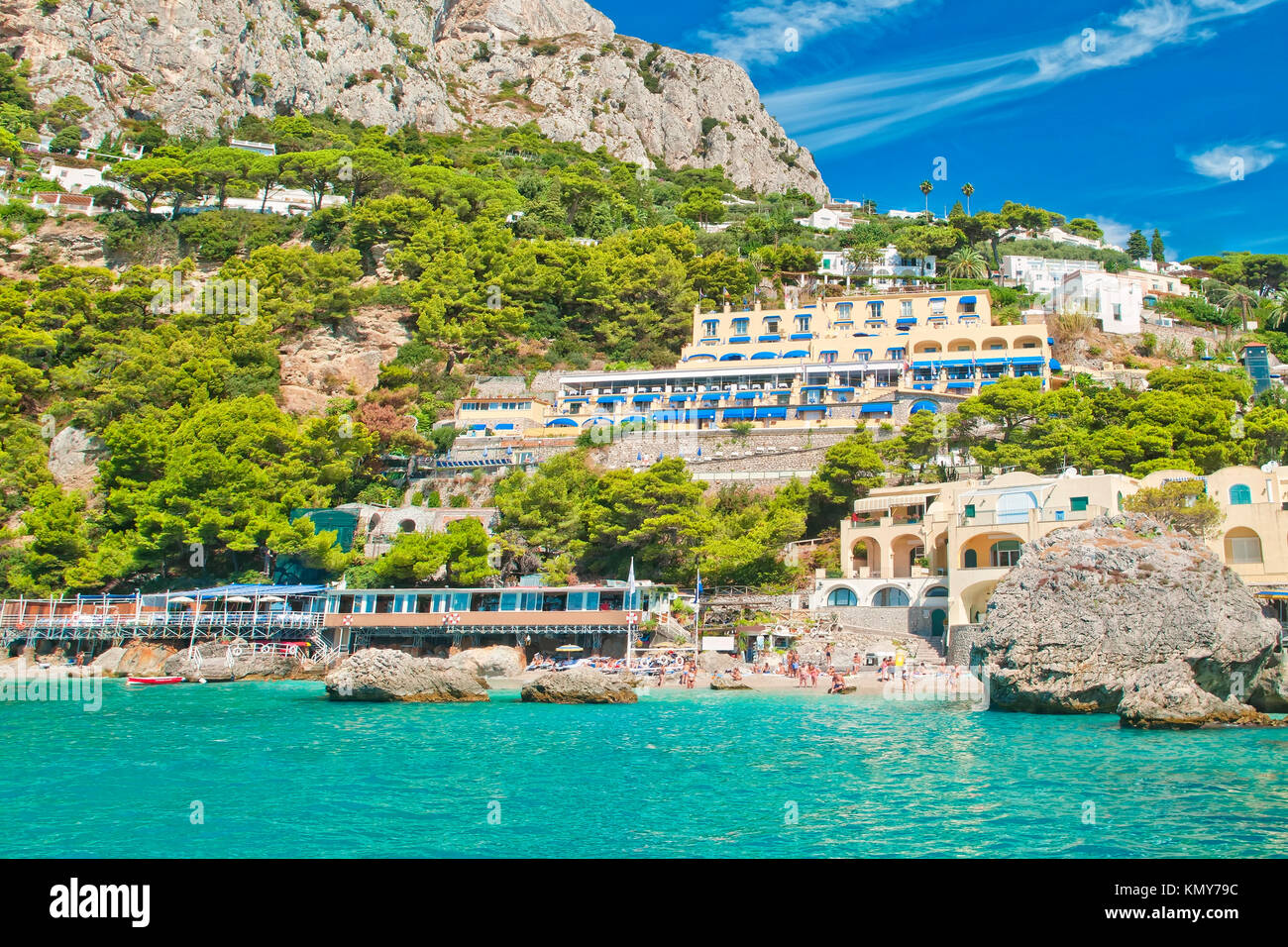 view of Marina Piccola beach from sea with mountain, hotels and restaurants behind it on sunny summer day, Capri, Italy Stock Photo