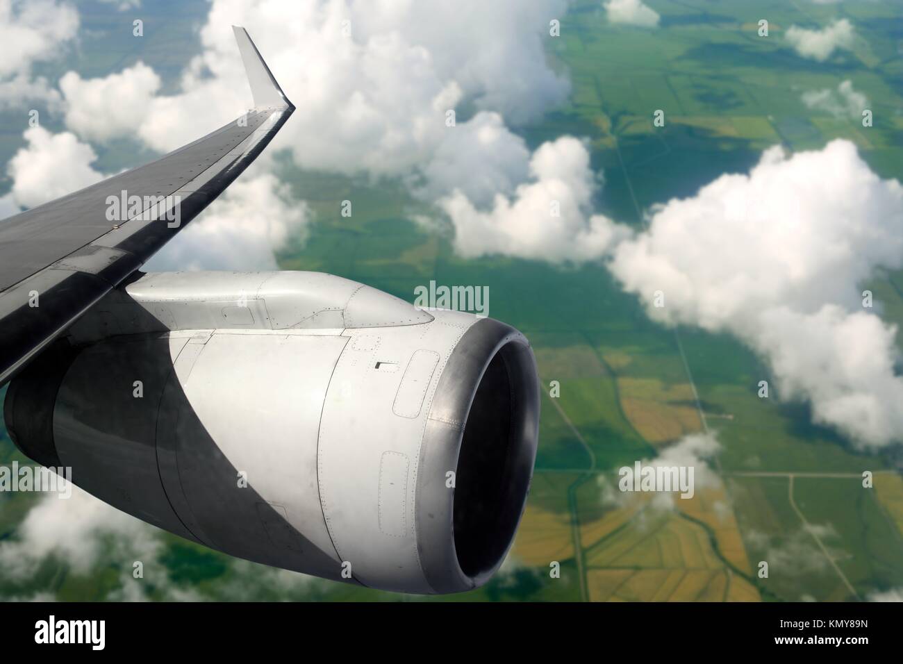 airplane wing aircraft turbine flying over agriculture fields Stock