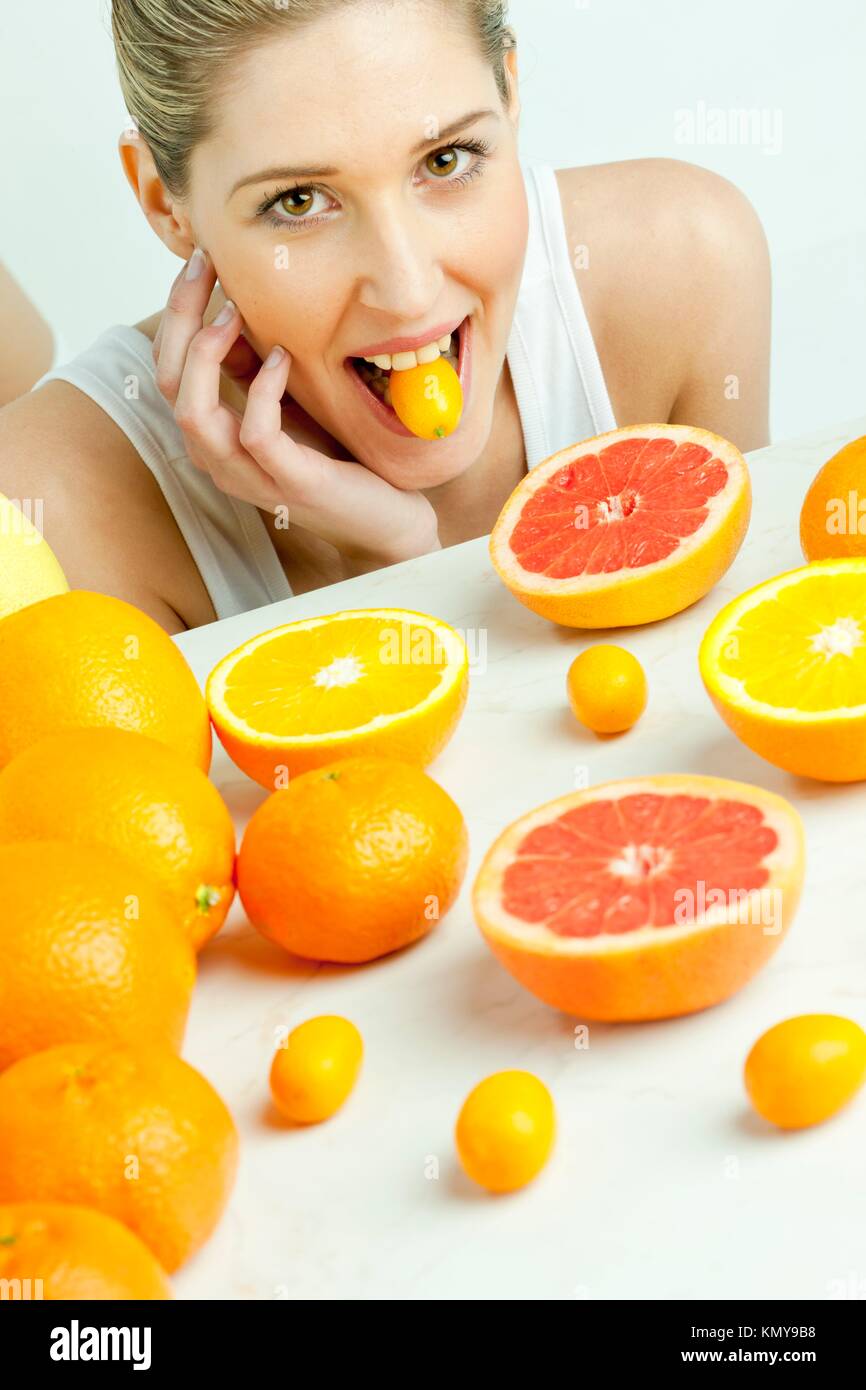 portrait of young woman with citrus fruit Stock Photo Alamy