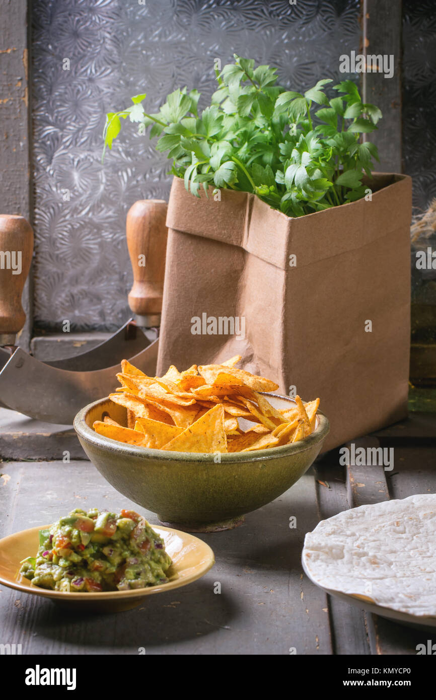 Mexican style dinner with tortilla, herbs, corn chips nachos and