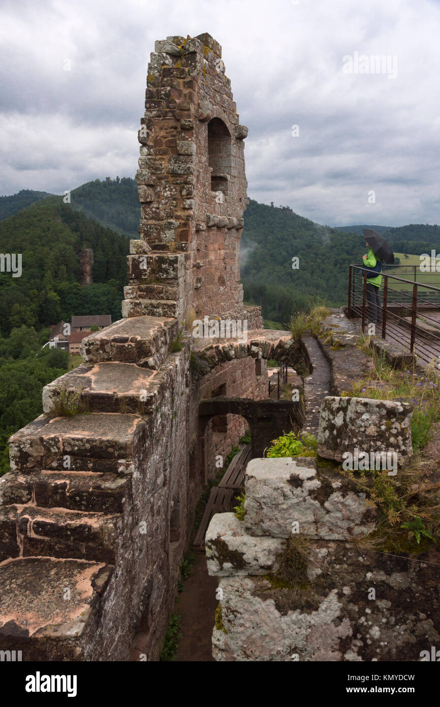 A tourist standing atop the ruins of the Château de Fleckenstein at Lembach, Alsace Stock Photo