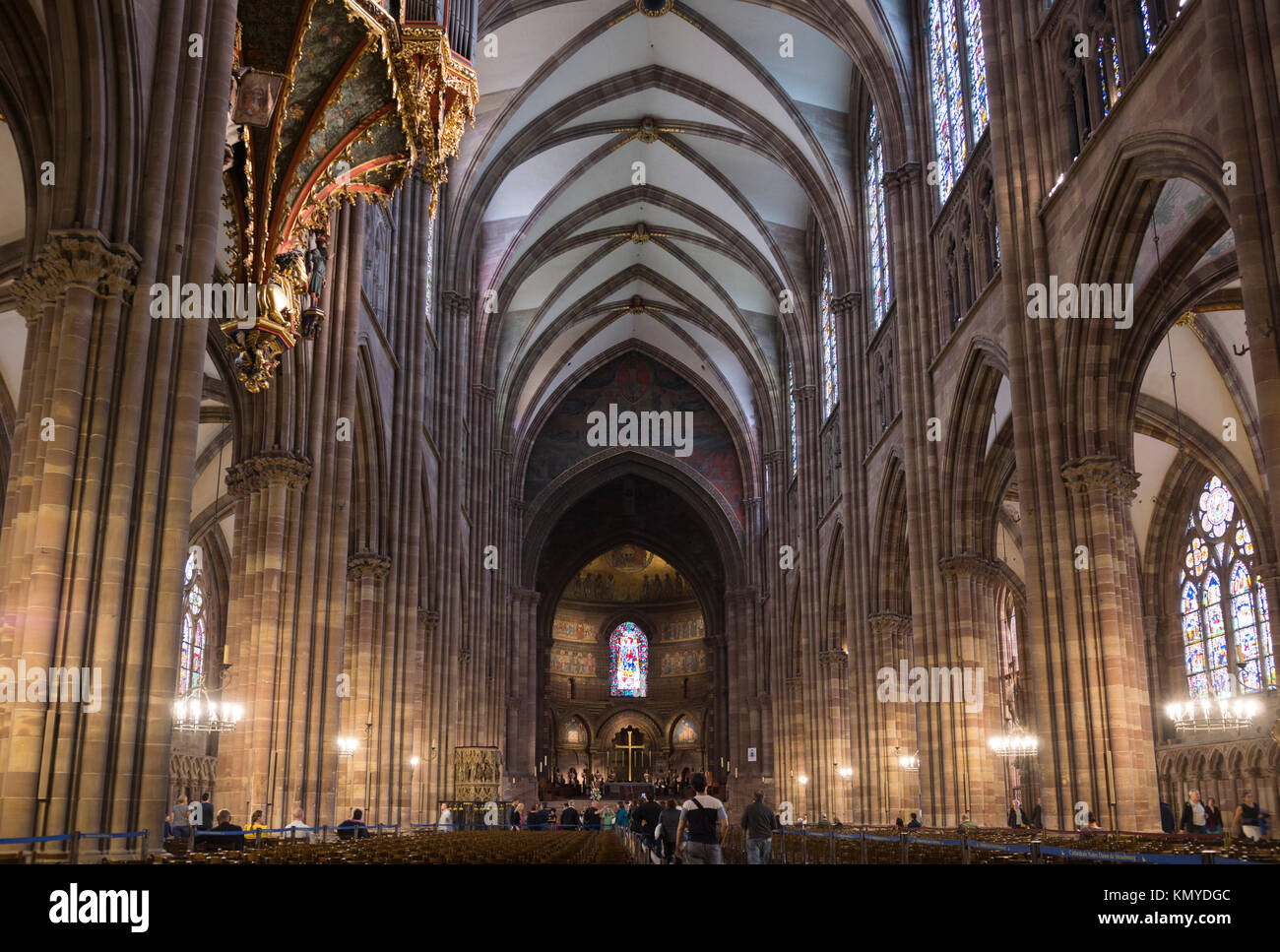 Tourists admiring the magnificent interior of Notre-Dame Cathedral, Strasbourg Stock Photo