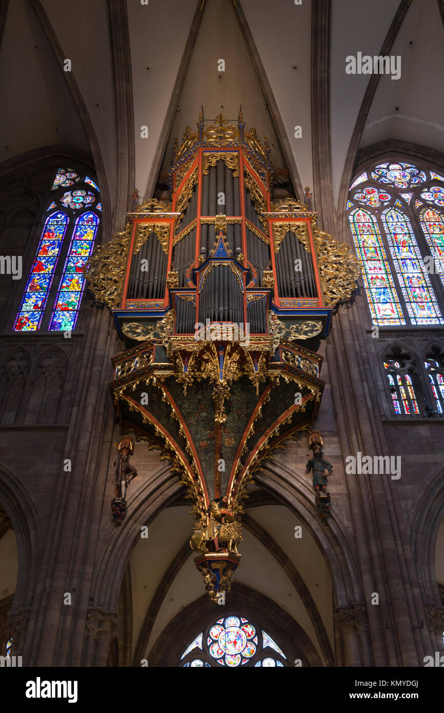 The organ in Strasbourg Notre Dame Cathedral has a magnificent polychrome organ case (14C and 15C) spanning the full width of a bay Stock Photo