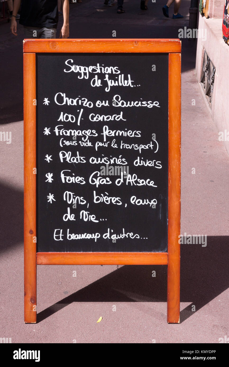 A chalk blackboard outside a restaurant in Colmar advertising local dishes from Alsace Stock Photo